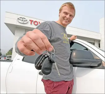  ?? To The Herald ?? MARK BRETT/Special
Connor Callaghan, whose truck was stolen while he battled the Christie Mountain wildfire, with the keys to a new truck presented to him Wednesday by Penticton Toyota and Toyota Canada.