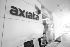  ??  ?? Axiata’s financial headroom would improve with the cancellati­on of its acquisitio­n of a Pakistani telecom tower company, according to S&amp;P. — Reuters photo