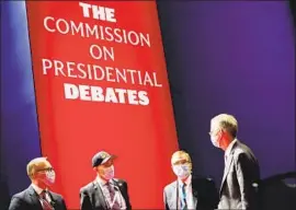  ?? Patrick Semansky Associated Press ?? IT REMAINS unclear what would take the place of presidenti­al debates if the Republican candidate were to boycott. Above, commission officials meet in 2020.