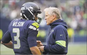  ?? Elaine Thompson / Associated Press ?? Seahawks coach Pete Carroll, shown talking with QB Russell Wilson on Dec. 22, said an unnamed NFL team called Thursday to ask him about Colin Kaepernick.