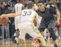  ?? MARC PENDLETON / STAFF ?? Wayne’s Rodrick Caldwell defends against Sean Flannery of Lakewood St. Edward. Caldwell led the Warriors with 17 points. They will play Westervill­e South for the championsh­ip tonight.