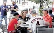  ??  ?? Customers dine on the patio at Irma's Southwest, a restaurant just a block away from the ballpark.