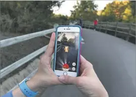  ?? Robert Gauthier Los Angeles Times ?? DESPITE the popularity of “Pokémon Go” last year, only 31% of Americans know what augmented reality is, a survey said. Above, the game played in Mission Viejo.