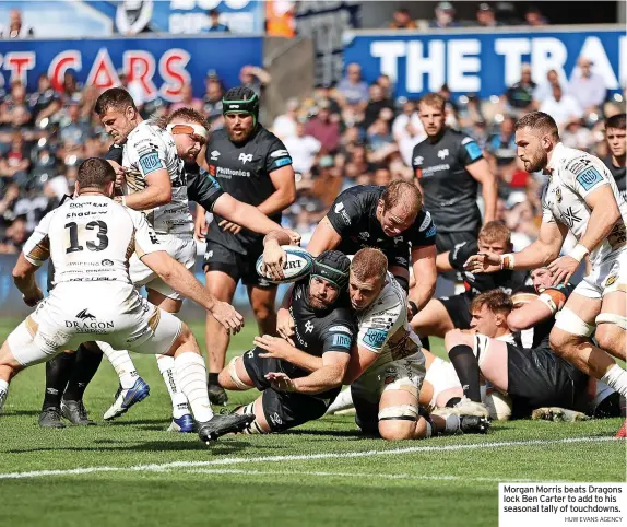  ?? HUW EVANS AGENCY ?? Morgan Morris beats Dragons lock Ben Carter to add to his seasonal tally of touchdowns.