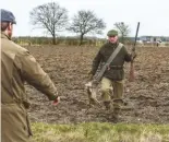  ??  ?? Richard Gould carries a hare across the plough