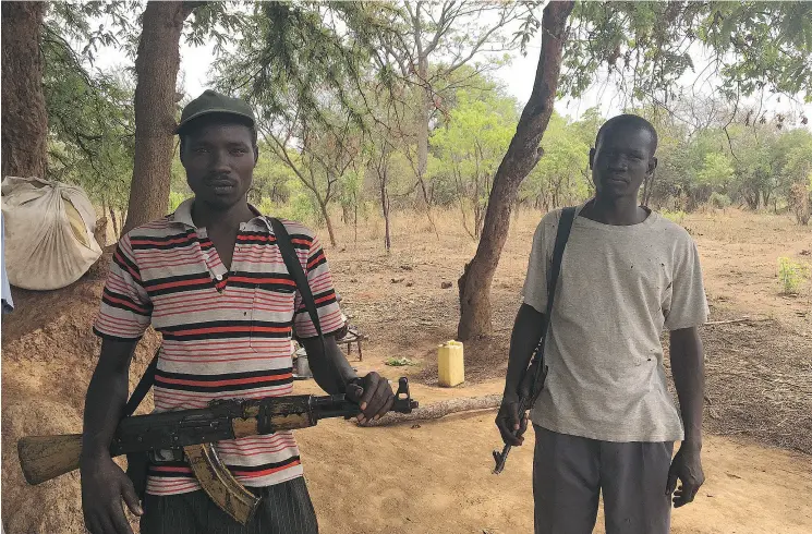  ?? MATTHEW FISHER ?? Soldiers from the South Sudan Liberation Army rest near the Ugandan border. The UN has declared that the civil war in South Sudan has created the world’s greatest humanitari­an crisis. But it’s a crisis that has been “growing silently beyond the eyes of...