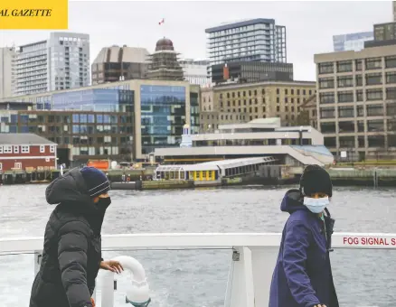  ?? TIM KROCHAK / BLOOMBERG ?? Passengers take their seats aboard a Metro Transit ferry in Halifax on Sunday, as the number of COVID cases in Atlantic Canada slowly tick upward.