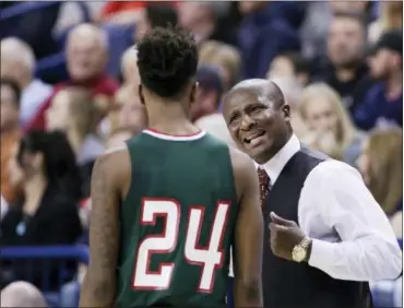  ?? YOUNG KWAK — THE ASSOCIATED PRESS FILE ?? Mississipp­i Valley State coach Andre Payne, right, speaks with guard Isaac Williams (24) during the team’s game against Gonzaga in Spokane, Wash. MVSU and Texas Southern are among a handful of lower-level Division I teams that lead a nomadic existence during non-conference play, traveling to play road games with guaranteed payouts. The odds of winning are usually not good, but the benefits can be.