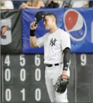  ?? BILL KOSTROUN — THE ASSOCIATED PRESS ?? New York Yankees right fielder Aaron Judge adjusts his cap after coming into the baseball game in the eighth inning against the Toronto Blue Jays Friday, Sept.14, 2018, at Yankee Stadium in New York.
