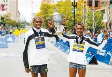  ?? The Associated Press ?? ■ Benson Kipruto, left, and Diana Kipyogei, both of Kenya, celebrate winning the men’s and women’s divisions of the 125th Boston Marathon on Monday in Boston.