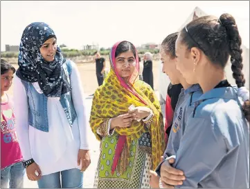  ??  ?? PLEA: Campaigner Malala Yousafzai, centre, at the opening of a Malala Fund girls’ school, as she marked her 18th birthday.