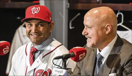  ?? JONATHAN NEWTON / WASHINGTON POST ?? General Manager Mike Rizzo introduces Dave Martinez as manager of the Washington Nationals in November. Martinez’s first spring training has been Camp Happy so far.