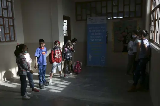  ?? Christian Chavez, The Associated Press ?? Child migrants from two pastor-run shelters gather in the hallway between their classrooms at Casa Kolping, an alternativ­e education center in Ciudad Juarez, Mexico, on March 28.