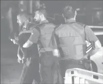  ?? (Reuters photo) ?? Spanish Civil Guards escort one of four men accused of involvemen­t in an Islamist cell behind a van attack in Barcelona last week, in Tres Cantos, Spain, August 21, 2017.