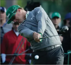  ?? The Associated Press ?? IT WAS YOU, CHARLEY: Charley Hoffman, here driving on the 18th hole, records four straight birdies on the back nine and leads the Masters by four strokes after a 7-under 65 Thursday at Georgia’s Augusta National Golf Club.