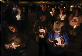  ?? Chesapeake City Park. Photograph: Carolyn Kaster/AP ?? Community members, including Walmart employees, gather for a candleligh­t vigil at