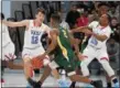  ?? PATRICK HOPKINS — THE NEWS-HERALD ?? Montorie Foster of St. Edward dribbles against Graham Koppleman (12) while Jerry Higgins tries to fight through a screen Jan. 27 at VASJ.