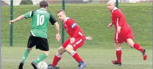  ?? Pictures: DAI SINCLAIR ?? Llangefni Town captain Andrew Sinclair (red - nearest ball) and Steve Kehoe during last weekend’s 2-1 win over Greenfield