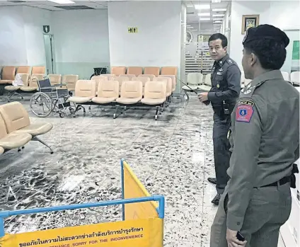  ?? PHOTOS BY THE ROYAL THAI POLICE ?? Police officers examine the scene of a blast on the first floor of Phramongku­tklao Hospital in Ratchathew­i district yesterday. Some 25 people were wounded, with one person described as critically injured.