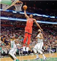  ?? —AP ?? Toronto Raptors forward OG Anunoby goes in for a dunk past Boston Celtics Terry Rozier (12) and Marcus Morris during the second quarter of an NBA game in Boston on Sunday. The Celtics won 95-94.