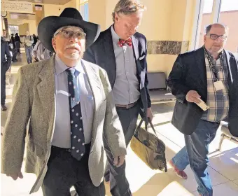  ?? MORGAN LEE/ASSOCIATED PRESS ?? Former state Sen. Phil Griego, left, and his attorney Tom Clark, center, walk out of an arraignmen­t in Santa Fe District Court in Santa Fe on April 4, 2016. Griego, a Democrat who is accused of using his former position as a lawmaker and his acumen as...