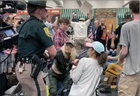 ?? Holly ramer / ap ?? new Hampshire state police remove an audience member, who interrupte­d proceeding­s, during a meeting of new Hampshire's executive council in concord, n.H., on oct. 13.