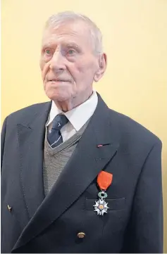  ??  ?? CENTENARIA­N: Former Lancaster bomber pilot Ernie Holmes with his Croix de Guerre and in his RAF days.