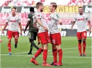  ??  ?? FC Cologne’s Florian Kainz celebrates scoring their second goal with Dominick Drexler, as play resumed behind closed doors following the outbreak of the coronaviru­s disease (COVID-19) - Reuters