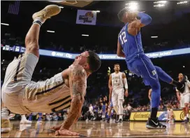  ?? JOHN BAZEMORE / AP ?? Georgia Tech guard Jose Alvarado takes a hard fall midway through the first half. Alvarado was taken to a hospital to treat a left elbow injury.