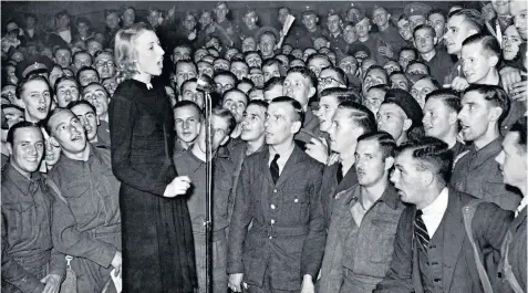  ??  ?? Forces sweetheart: Vera Lynn singing for the troops in September 1940, above; and marking her 100th birthday in 2017, below