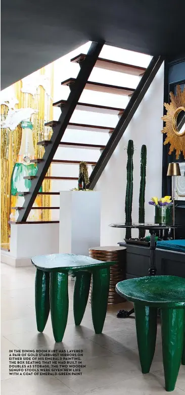  ??  ?? in the dining room Kurt has layered a pair of gold starburst mirrors on either side of his emerald painting. the box seating that he had built in doubles as storage. the two wooden senufo stools were given new life with a coat of emerald-green paint