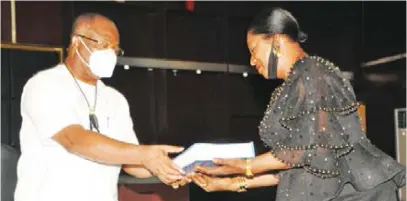  ??  ?? Gov. Uzodimma receiving the report of the Judicial Commission of Inquiry on Lands and Related Matters from Florence Duruoha-Igwe, a retired justice