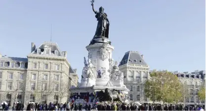  ??  ?? PARIS: People gather at Place de la Republique (Republic Square) in Paris yesterday to pay tribute to the victims of the November 13 terror attacks. — AFP