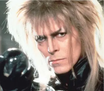  ??  ?? In “Labyrinth,” David Bowie plays the Goblin King who kidnaps a baby and will return him to his sister only if the girl can reach a castle inside a treacherou­s maze.