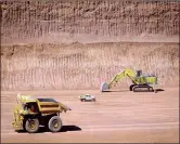  ?? PHOTO: BLOOMBERG ?? Vehicles operate in a pit at Rio Tinto’s West Angelas iron ore mine in Pilbara, Australia. The group has announced a 10 million ton cut in annual production.