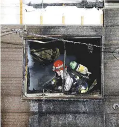  ??  ?? A firefighte­r inspects the building in Sapporo in this photo taken by Kyodo yesterday.