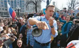  ?? KIRILL KUDRYAVTSE­V/GETTY-AFP 2018 ?? Kremlin critic Alexei Navalny addresses supporters at an unauthoriz­ed Moscow rally, two days before Vladimir Putin’s inaugurati­on for a fourth term.