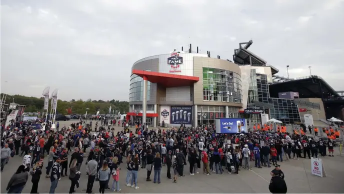  ?? AP FILe PHoToS ?? LINING UP TO GET IN: Fans line up to enter Gillette Stadium for a game between the Patriots and the Colts. When stadiums reopen, fans might be given an entrance time to prevent crowds at the gate.