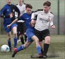  ??  ?? Fionn Matthews of Ashford Rovers looks to close down Arklow Town’s Chris Furlong.