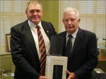  ??  ?? John Riordan receives second prize in the 2018 Captain’s Prize at County Louth Golf Club from Pat McCabe.