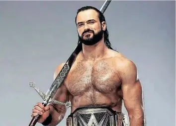  ?? Pinterest ?? SCOTTISH Warrior Drew McIntyre with sword Angela, named after his late mother.
|