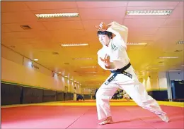  ??  ?? Japanese 35-year-old black belt Yuko Fujii, head coach of the Brazilian men’s national
team, warms up before giving a class in Rio de Janeiro, Brazil on June 26. (AFP)