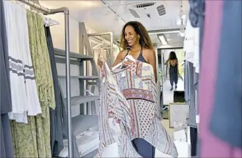  ?? Pam Panchak/Post-Gazette photos ?? Kat Marryshow Katawczik rearranges merchandis­e in her fashion truck, Bow by Kat.