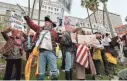  ?? RICHARD VOGEL/AP ?? Demonstrat­ors protest President Donald Trump in Los Angeles on Monday as part of a “Not My President’s Day” rally.