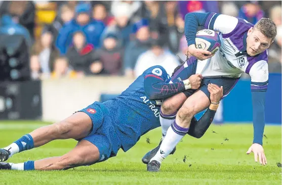  ?? Picture: SNS. ?? Finn Russell is tackled by French star Teddy Thomas before he was substitute­d as Scotland made a key tactical change.