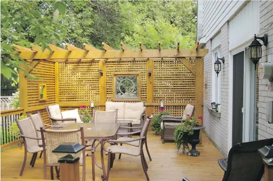  ?? MONTREAL GAZETTE FILES PHOTO COURTESY OF PROSCAPE, ?? A deck with a privacy screen provides a cosy outdoor space where the homeowner’s family can gather without feeling as if they’re on display for the neighbours.