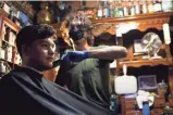  ?? THOMAS HAWTHORNE/THE REPUBLIC ?? Zakk Tokash cuts Sebastian Molina’s hair
at Matt’s Barber Parlor in Phoenix.