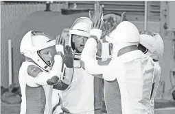  ?? GREGG NEWTON/GETTY-AFP ?? Astronauts including Jessica Watkins, left, and Bob Hines rally before the SpaceX launch on Wednesday at the Kennedy Space Center in Florida.