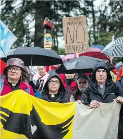  ?? DARRYL DYCK / THE CANADIAN PRESS ?? People listen as religious leaders and more than 100 members of diverse faith communitie­s participat­e in a protest against the Trans Mountain Pipeline expansion.