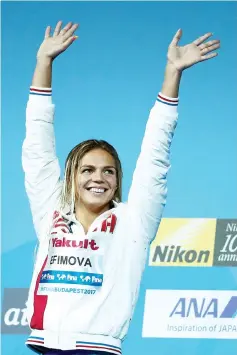  ?? — AFP photo ?? Russia's Yuliya Efimova celebrates on the podium after the women's 200m breaststro­ke final during the swimming competitio­n at the 2017 FINAWorld Championsh­ips in Budapest, on July 28, 2017.